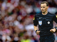 Referee Sander van der Eijk officiates the match between Feyenoord and NAC at Stadium De Kuip for the Dutch Eredivisie season 2024-2025 in R...