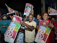 Supporters of Sri Lanka's new president, Anurakumara Dissanayake, celebrate his victory outside the election commission in Colombo, Sri Lank...