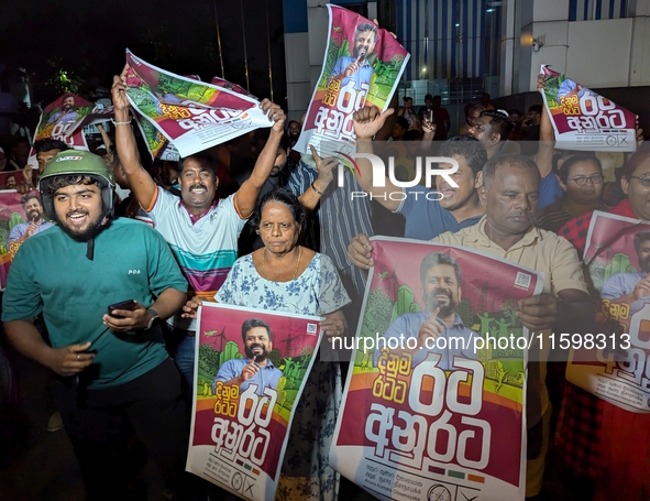 Supporters of Sri Lanka's new president, Anurakumara Dissanayake, celebrate his victory outside the election commission in Colombo, Sri Lank...