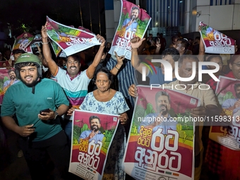 Supporters of Sri Lanka's new president, Anurakumara Dissanayake, celebrate his victory outside the election commission in Colombo, Sri Lank...