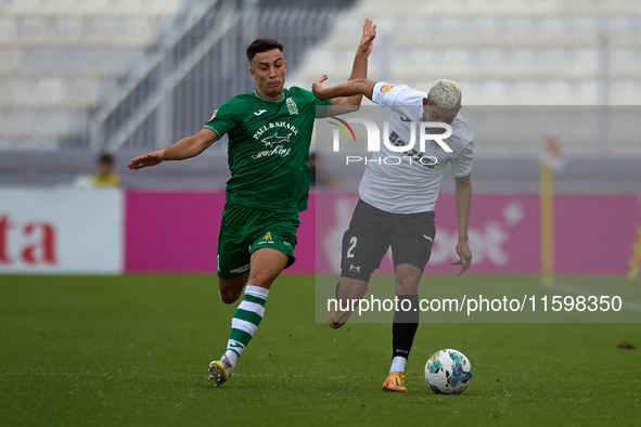 Carlo Zammit Lonardelli of Floriana closely follows Alex Bruno de Souza Silva of Hibernians during the Malta 360 Sports Premier League socce...