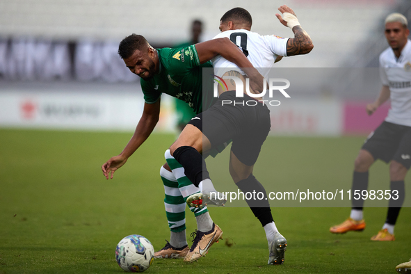 Oualid El Hasni of Floriana competes for the ball with Miullen Natha Felicio Carvalho of Hibernians during the Malta 360 Sports Premier Leag...