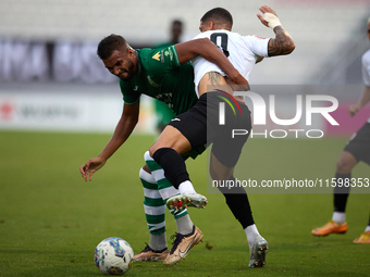 Oualid El Hasni of Floriana competes for the ball with Miullen Natha Felicio Carvalho of Hibernians during the Malta 360 Sports Premier Leag...