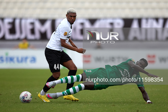 In Ta' Qali, Malta, on September 22, 2024, Franklin Sasere (R) of Floriana is challenged by Nunes Silva Pedro Henrique (L) of Hibernians dur...