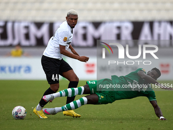 In Ta' Qali, Malta, on September 22, 2024, Franklin Sasere (R) of Floriana is challenged by Nunes Silva Pedro Henrique (L) of Hibernians dur...