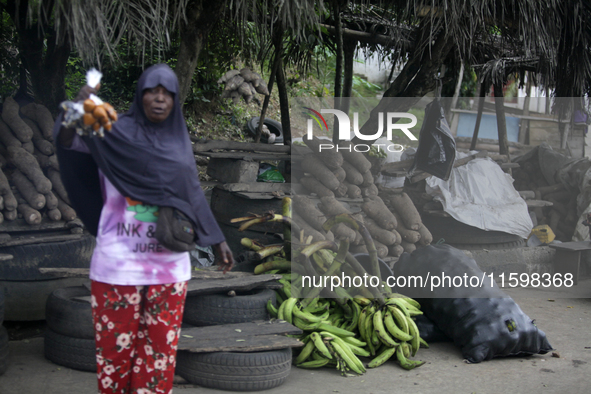 A woman displays local snacks at Akinola Market, Ipetu, as business activities boom along Ife-Ibadan Expressway in Osun State, Nigeria, on S...