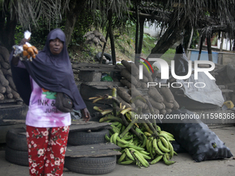 A woman displays local snacks at Akinola Market, Ipetu, as business activities boom along Ife-Ibadan Expressway in Osun State, Nigeria, on S...