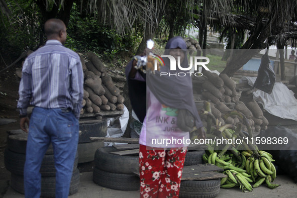 A woman displays local snacks at Akinola Market, Ipetu, as business activities boom along Ife-Ibadan Expressway in Osun State, Nigeria, on S...