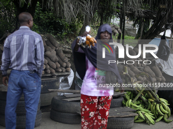 A woman displays local snacks at Akinola Market, Ipetu, as business activities boom along Ife-Ibadan Expressway in Osun State, Nigeria, on S...