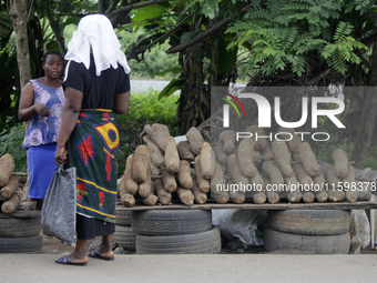 A woman negotiates with a yam seller at Akinola Market, Ipetu, along Ife-Ibadan Expressway in Osun State, Nigeria, on September 20, 2024. Ma...