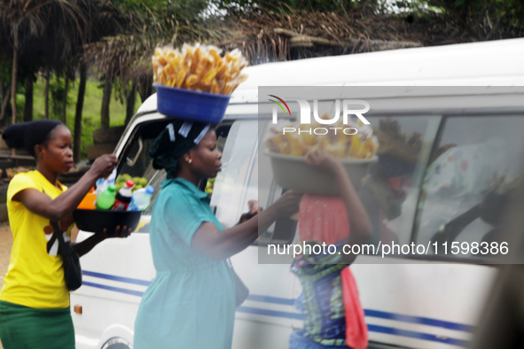 Hawkers approach travelers along Ife-Ibadan Expressway in Osun State, Nigeria, on September 20, 2024. Many city dwellers and travelers opt t...