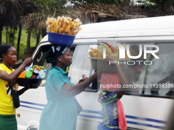 Hawkers approach travelers along Ife-Ibadan Expressway in Osun State, Nigeria, on September 20, 2024. Many city dwellers and travelers opt t...