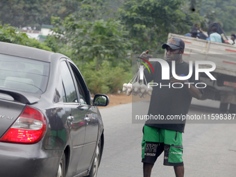 A man sells eggs along Ife-Ibadan Expressway in Osun State, Nigeria, on September 20, 2024. Many city dwellers and travelers opt to buy raw...