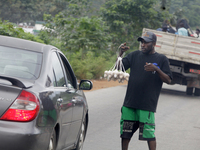 A man sells eggs along Ife-Ibadan Expressway in Osun State, Nigeria, on September 20, 2024. Many city dwellers and travelers opt to buy raw...