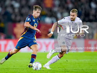 Tommaso Baldanzi of AS Roma and Sandi Lovric of Udinese Calcio compete for the ball during the Serie A Enilive match between AS Roma and Udi...