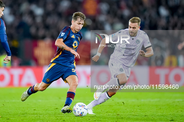 Tommaso Baldanzi of AS Roma and Sandi Lovric of Udinese Calcio compete for the ball during the Serie A Enilive match between AS Roma and Udi...