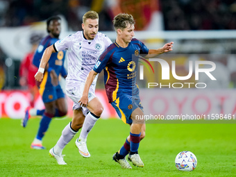 Tommaso Baldanzi of AS Roma and Sandi Lovric of Udinese Calcio compete for the ball during the Serie A Enilive match between AS Roma and Udi...