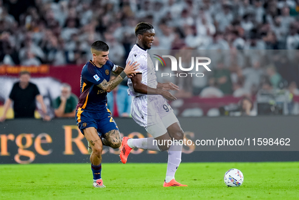 Gianluca Mancini of AS Roma and Isaak Toure' of Udinese Calcio compete for the ball during the Serie A Enilive match between AS Roma and Udi...