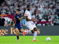 Gianluca Mancini of AS Roma and Isaak Toure' of Udinese Calcio compete for the ball during the Serie A Enilive match between AS Roma and Udi...