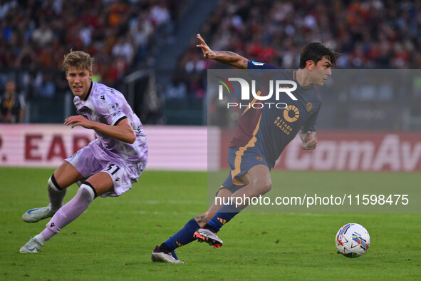 Thomas Thiesson Kristensen of Udinese Calcio and Paulo Dybala of A.S. Roma are in action during the 5th day of the Serie A Championship betw...