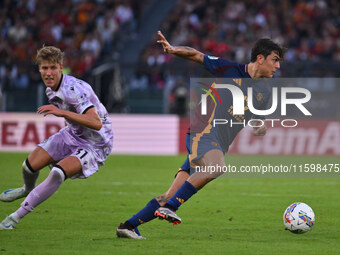 Thomas Thiesson Kristensen of Udinese Calcio and Paulo Dybala of A.S. Roma are in action during the 5th day of the Serie A Championship betw...