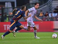 Angelino of A.S. Roma and Florian Thauvin of Udinese Calcio are in action during the 5th day of the Serie A Championship between A.S. Roma a...