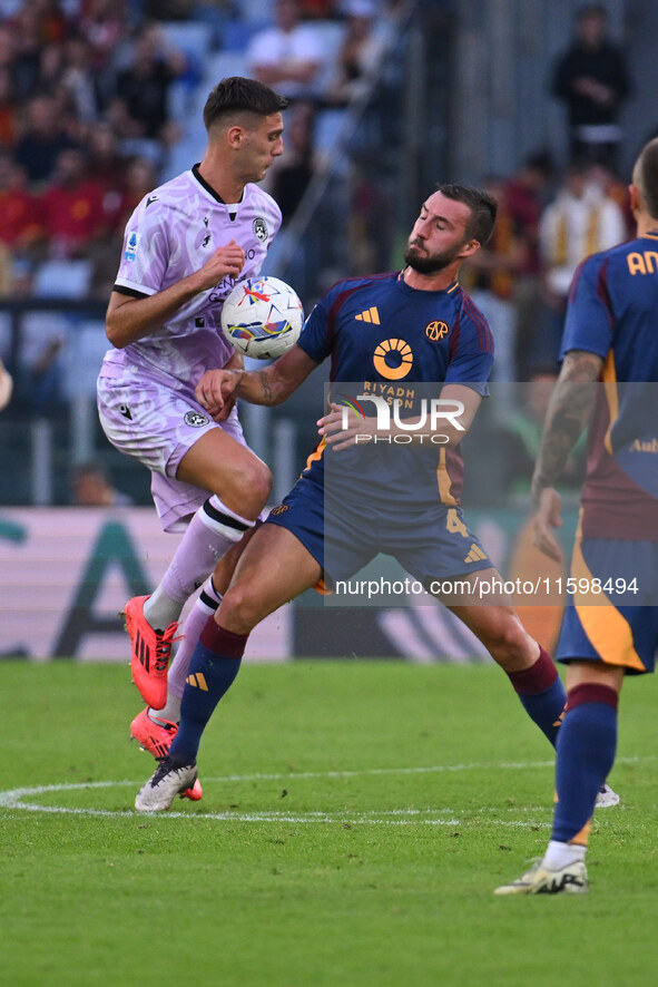 Lorenzo Lucca of Udinese Calcio and Bryan Cristante of A.S. Roma are in action during the 5th day of the Serie A Championship between A.S. R...