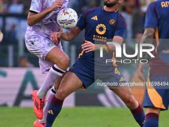 Lorenzo Lucca of Udinese Calcio and Bryan Cristante of A.S. Roma are in action during the 5th day of the Serie A Championship between A.S. R...