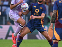 Lorenzo Lucca of Udinese Calcio and Bryan Cristante of A.S. Roma are in action during the 5th day of the Serie A Championship between A.S. R...