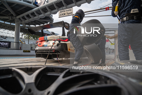 Marco Cassara, Philippe Denes, and Felice Jelmini of the BMW Italia Ceccato Racing team perform a pit stop on a BMW M4 GT3 during the Fanate...