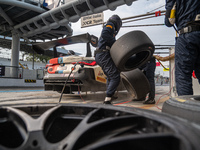 Marco Cassara, Philippe Denes, and Felice Jelmini of the BMW Italia Ceccato Racing team perform a pit stop on a BMW M4 GT3 during the Fanate...