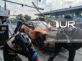 Jens Klingmann, Ahmad Al Harthy, and Sam De Haan of the team OQ by Oman Racing perform a pit stop on a BMW M4 GT3 during the Fanatec GT Worl...