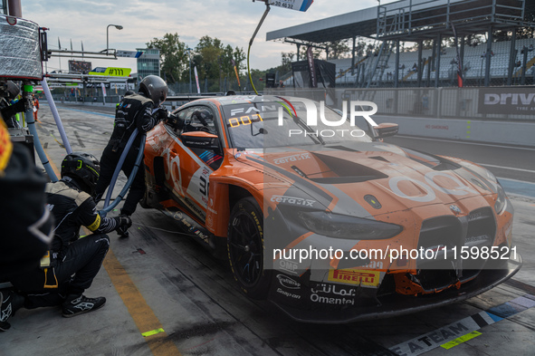 Jens Klingmann, Ahmad Al Harthy, and Sam De Haan of the team OQ by Oman Racing perform a pit stop on a BMW M4 GT3 during the Fanatec GT Worl...