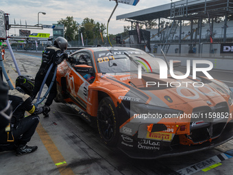 Jens Klingmann, Ahmad Al Harthy, and Sam De Haan of the team OQ by Oman Racing perform a pit stop on a BMW M4 GT3 during the Fanatec GT Worl...