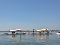 Supporters of the National Conference, a regional political party, hold a boat rally ahead of the second phase of assembly elections in Dal...