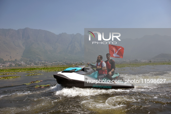 Supporters of the National Conference, a regional political party, hold a boat rally ahead of the second phase of assembly elections in Dal...