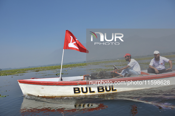 Supporters of the National Conference, a regional political party, hold a boat rally ahead of the second phase of assembly elections in Dal...