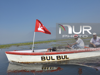 Supporters of the National Conference, a regional political party, hold a boat rally ahead of the second phase of assembly elections in Dal...