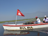 Supporters of the National Conference, a regional political party, hold a boat rally ahead of the second phase of assembly elections in Dal...