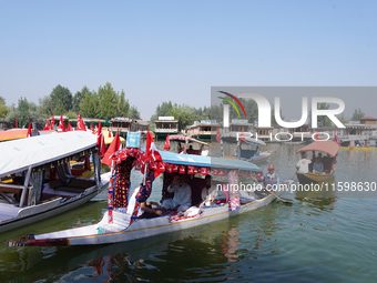 Supporters of the National Conference, a regional political party, hold a boat rally ahead of the second phase of assembly elections in Dal...