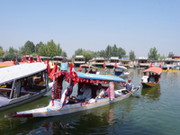 Supporters of the National Conference, a regional political party, hold a boat rally ahead of the second phase of assembly elections in Dal...