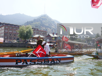 Supporters of the National Conference, a regional political party, hold a boat rally ahead of the second phase of assembly elections in Dal...