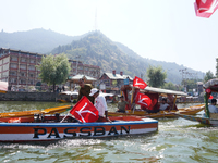 Supporters of the National Conference, a regional political party, hold a boat rally ahead of the second phase of assembly elections in Dal...