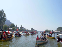 Supporters of the National Conference, a regional political party, hold a boat rally ahead of the second phase of assembly elections in Dal...