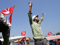 A supporter of the National Conference, a regional political party, shouts slogans during a boat rally ahead of the second phase of assembly...