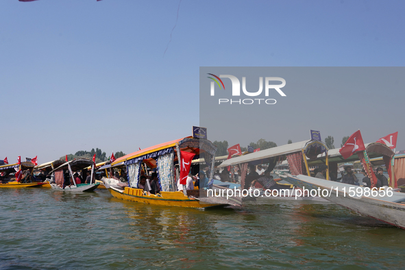 Supporters of the National Conference, a regional political party, hold a boat rally ahead of the second phase of assembly elections in Dal...