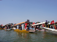 Supporters of the National Conference, a regional political party, hold a boat rally ahead of the second phase of assembly elections in Dal...