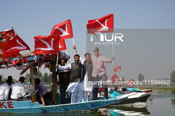 Omar Abdullah, leader of the National Conference, a regional political party, holds his party flag during a boat rally ahead of the second p...