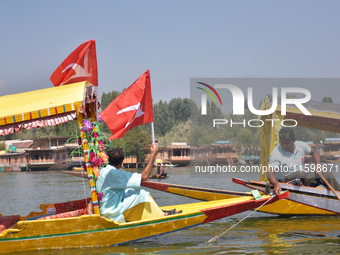 Supporters of the National Conference, a regional political party, hold a boat rally ahead of the second phase of assembly elections in Dal...