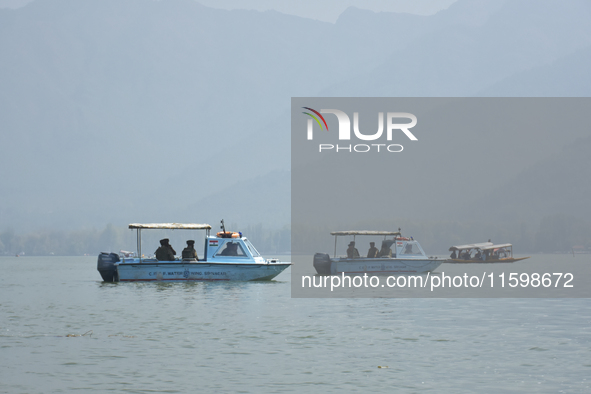 Indian troopers remain alert as the National Conference, a regional political party, holds a boat rally ahead of the second phase of assembl...